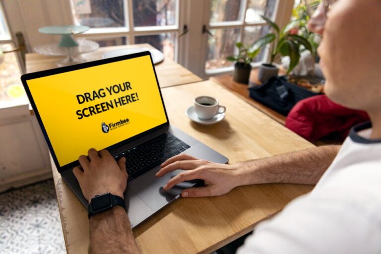 Professional web designer creating responsive custom website layout on laptop