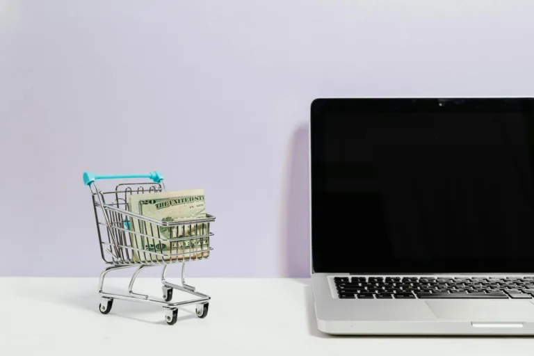 Laptop with shopping cart and money representing affiliate marketing programs