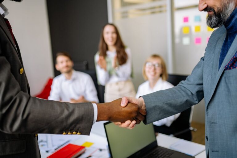 How to choose an SEO agency that delivers results: professional handshake representing a trusted SEO partnership for business growth Rank Ray